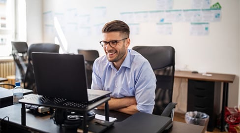 a man laughing at the computor