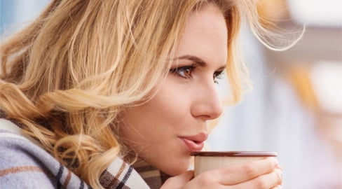 a woman holding a cup